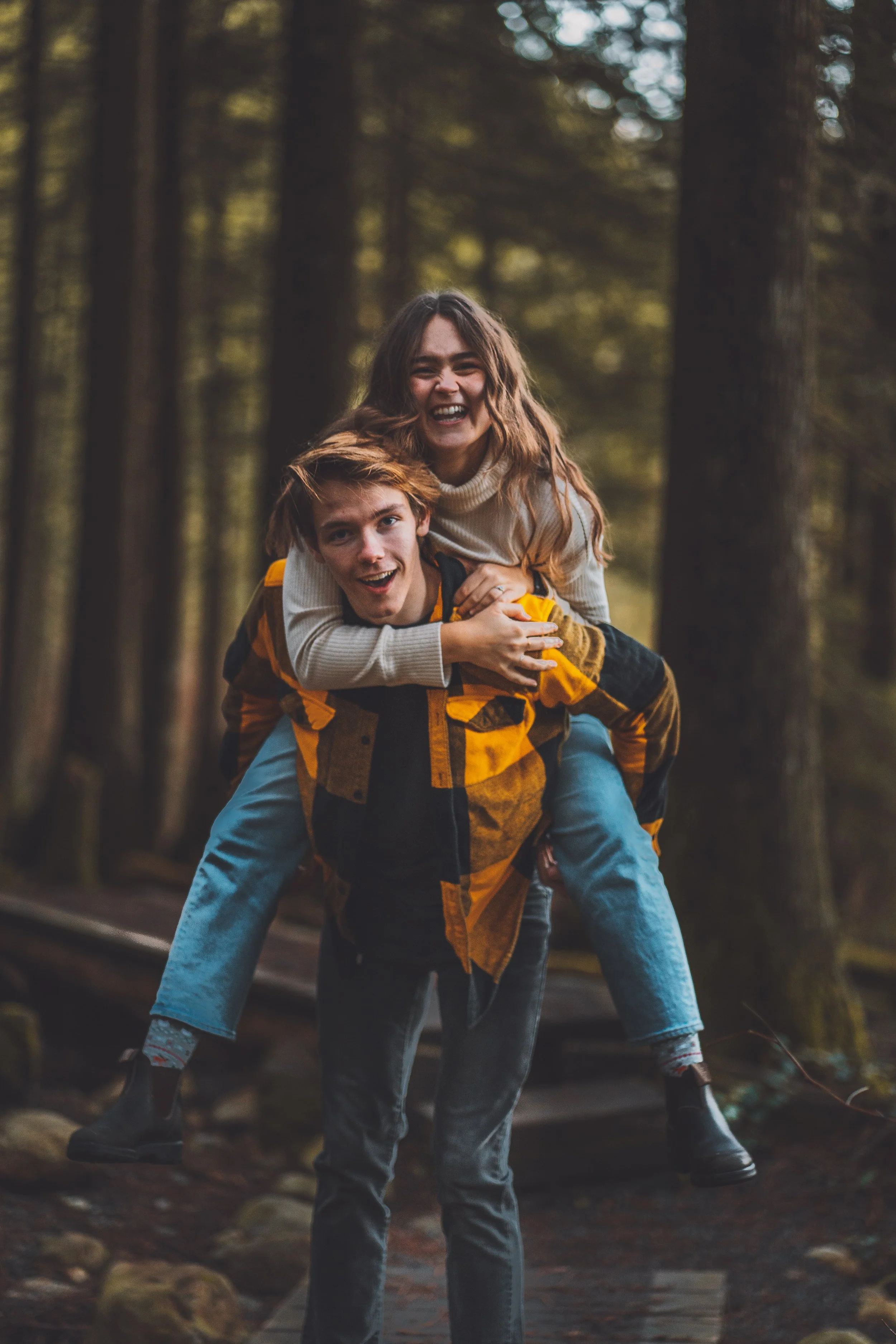 Couples counselling and marriage counselling showing a man giving his partner a playful piggyback ride, both laughing and enjoying their connection.