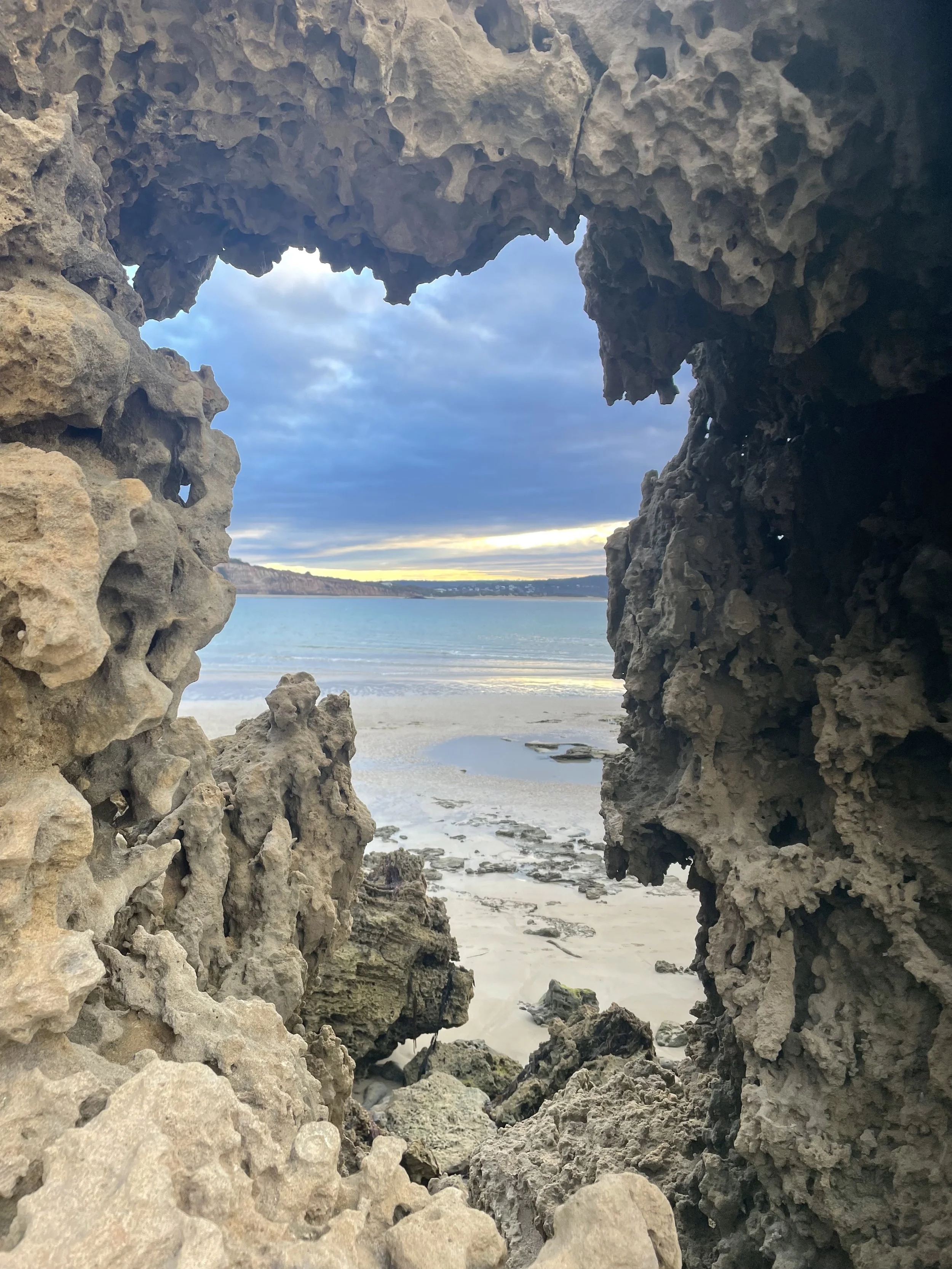 Schema therapy, looking through a gap toward the ocean symbolising expanding self-understanding and new perspective