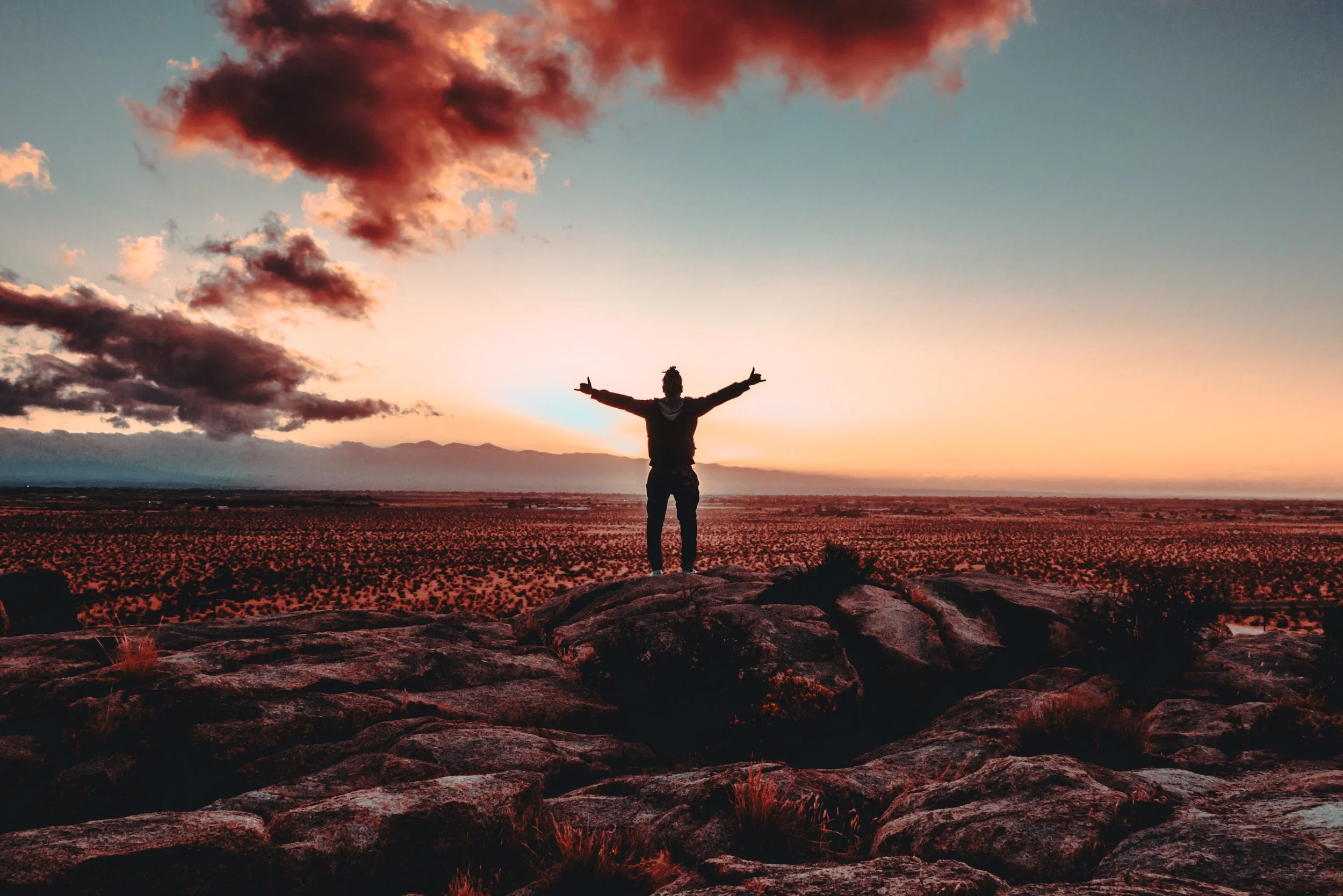 Trauma therapist EMDR - man standing with arms open, expression of freedom representing how clients feel after intensive EMDR therapy.