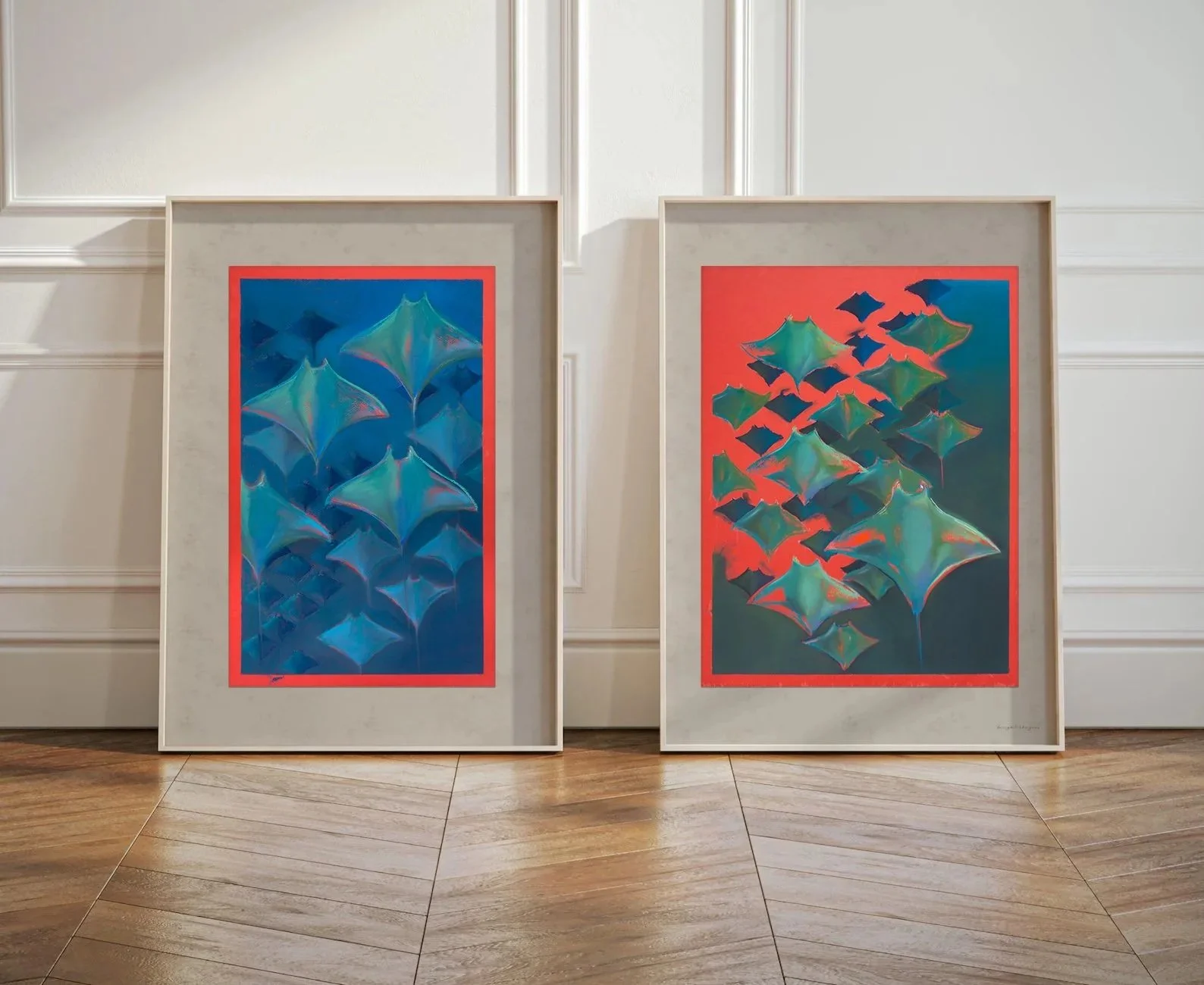 Two framed abstract paintings, featuring colorful geometric shapes resembling floating or flying objects, leaning against a white wall with wooden flooring.