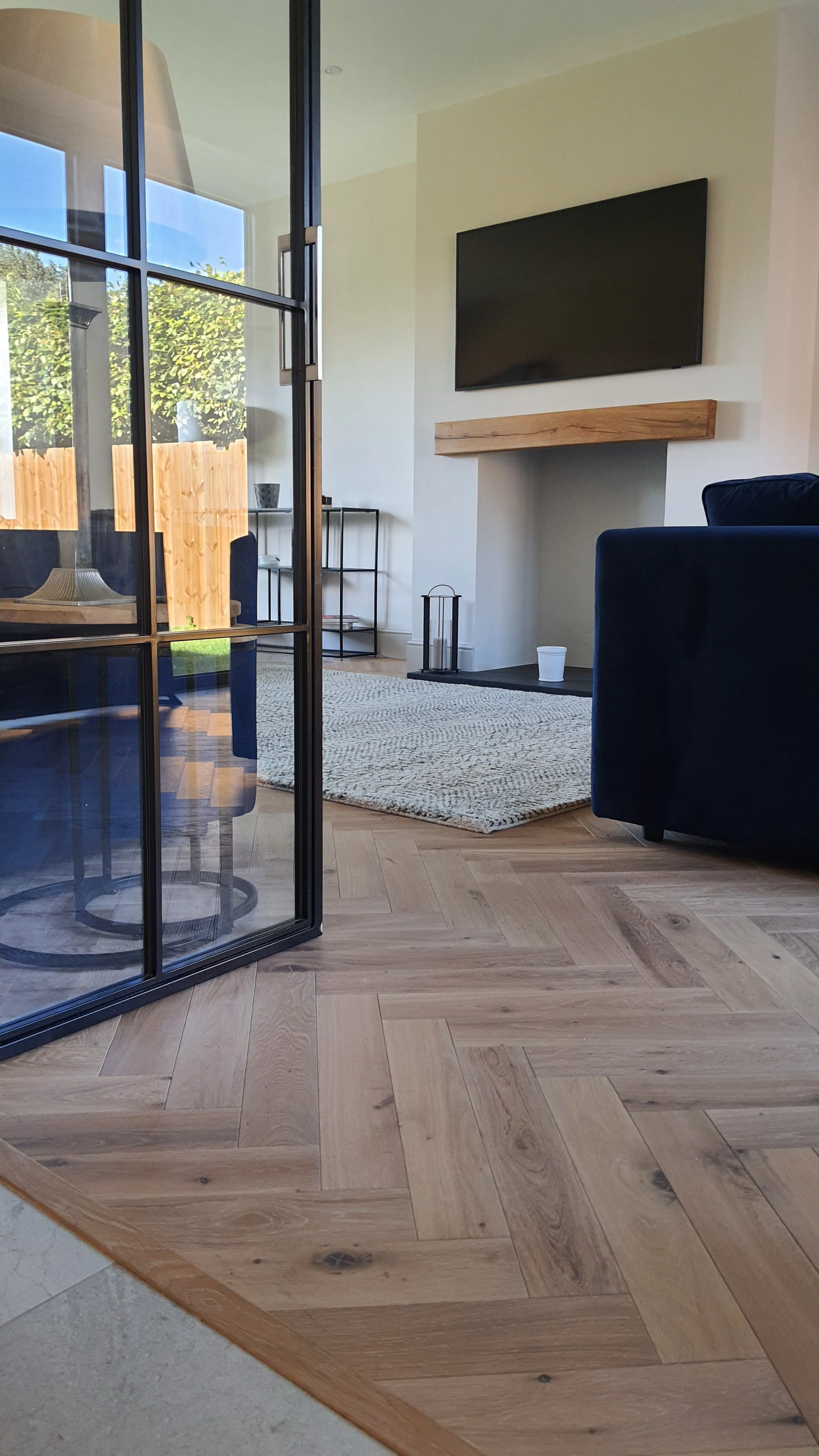Light bespoke parquet flooring installed in a living room
