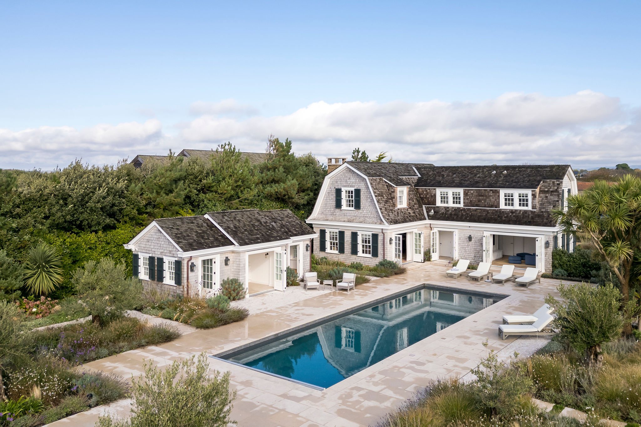 Quartet Architecture Ltd — A New England style house on the south coast with swimming pool and pool house with redesigned gardens.