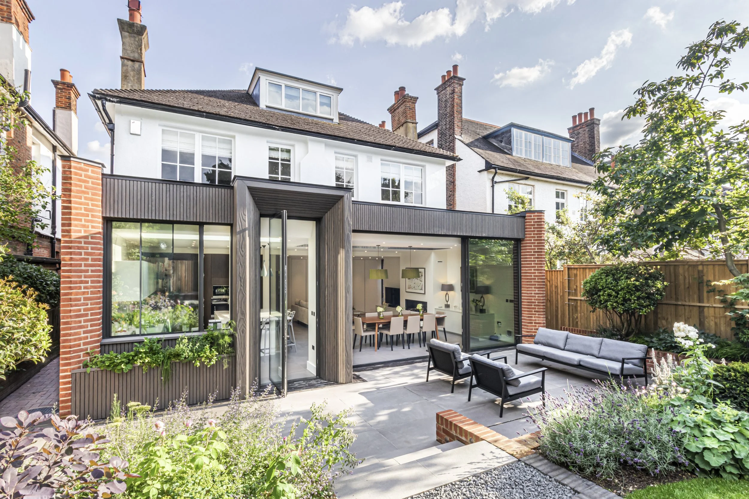 Quartet Architecture Ltd — Single storey rear extension in charred timber and brick