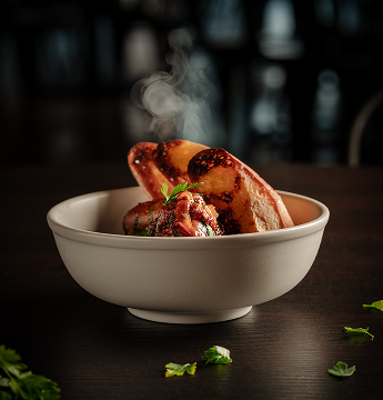 Small plate of appetizer with steaming bread