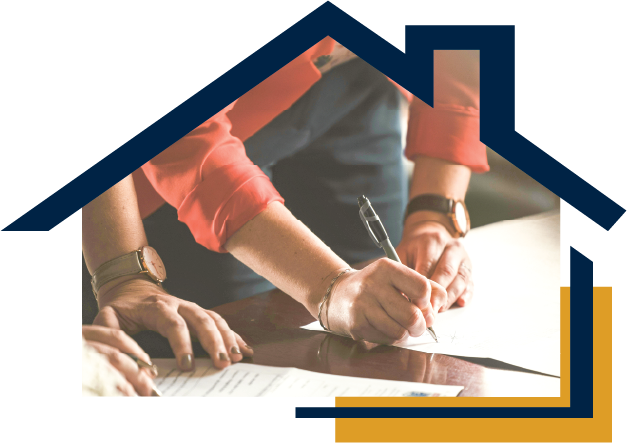 People signing paperwork at a table