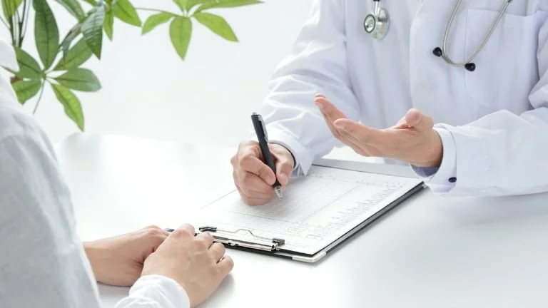 Consultant discussing treatment options with a patient during a spinal consultation