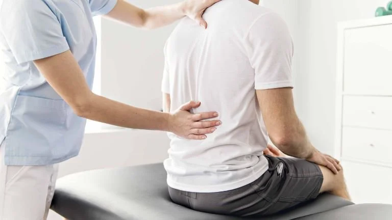 Back pain specialist looking at a person recovering from lumbar decompression