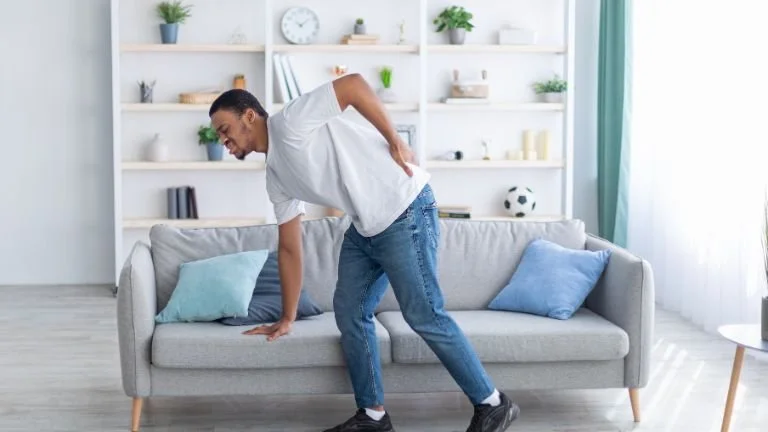 Man recovering at home post spinal surgery