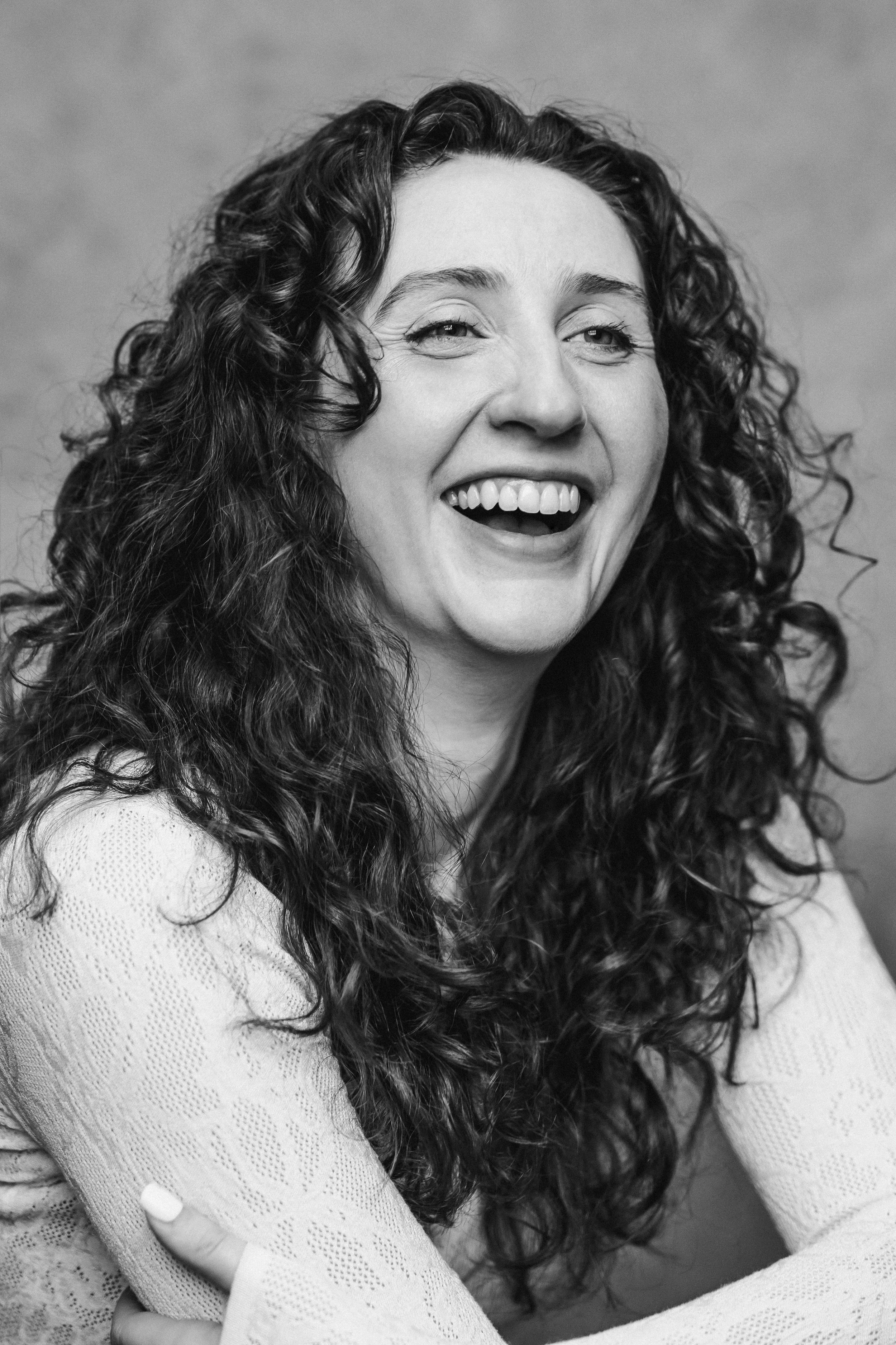 Katherine Lyle laughing headshot black and white