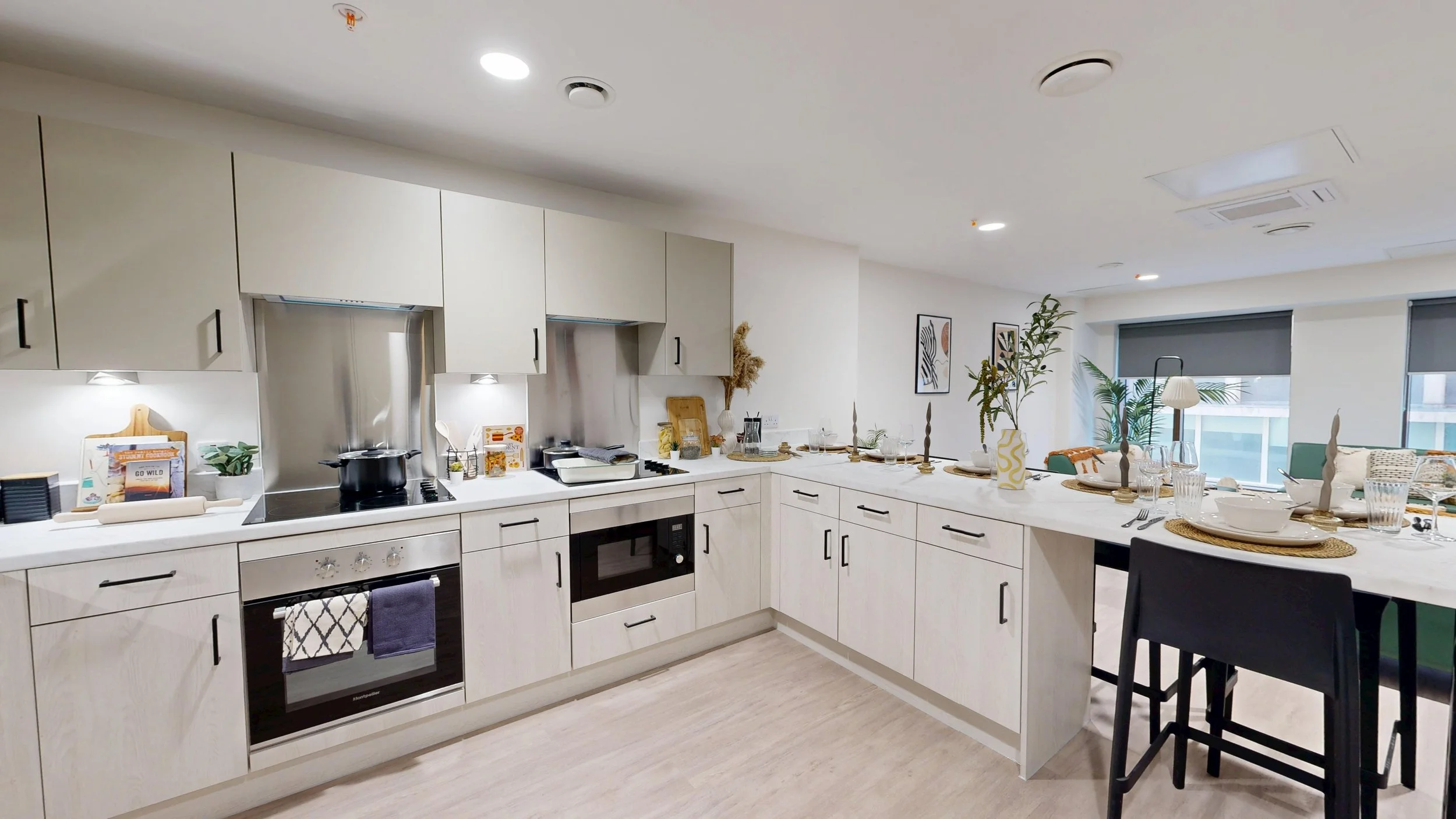 Shared student kitchen with modern cabinetry and durable worktops by Deanestor