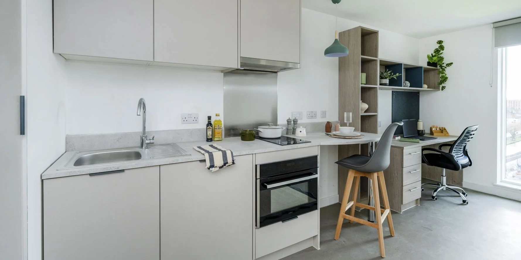 Student studio apartment at Timber Yard Bristol featuring bespoke fitted furniture by Deanestor, including a bed, study desk, storage solutions and integrated kitchenette.