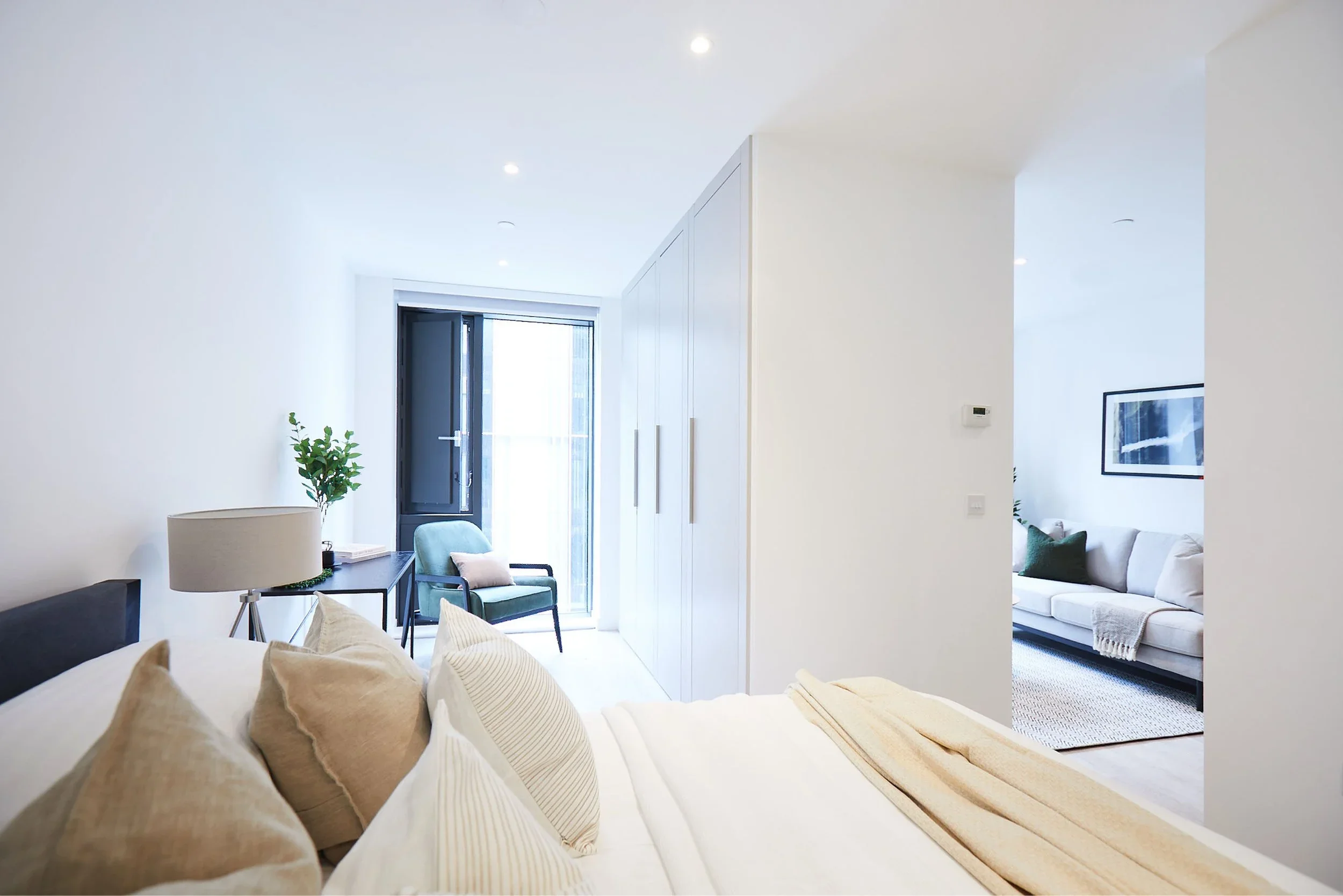 Bespoke fitted wardrobe solution within a contemporary residential apartment interior.