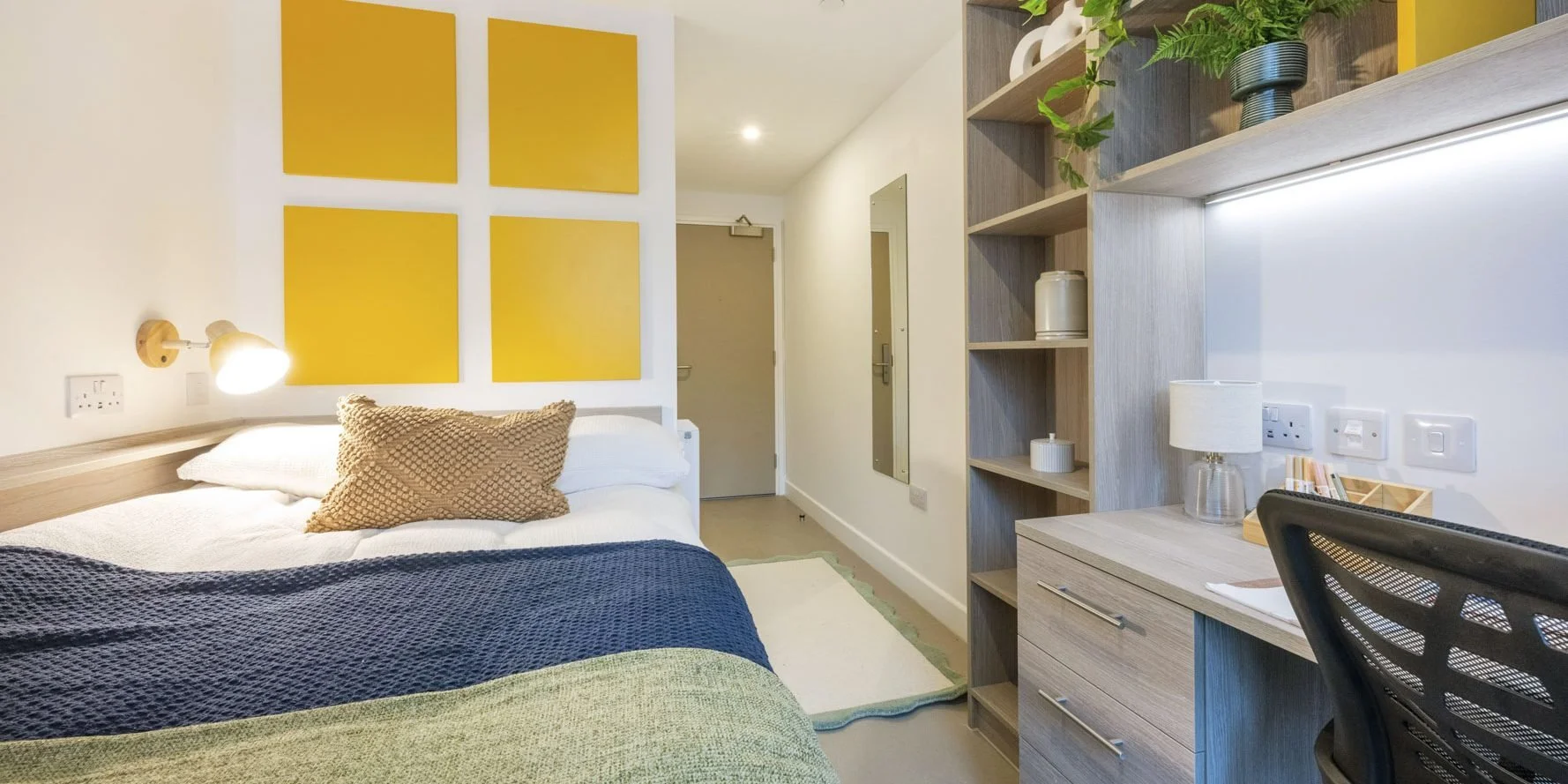 Student bedroom at Timber Yard Bristol showcasing Deanestor’s bespoke fitted furniture, including a bed, storage solutions and study space.