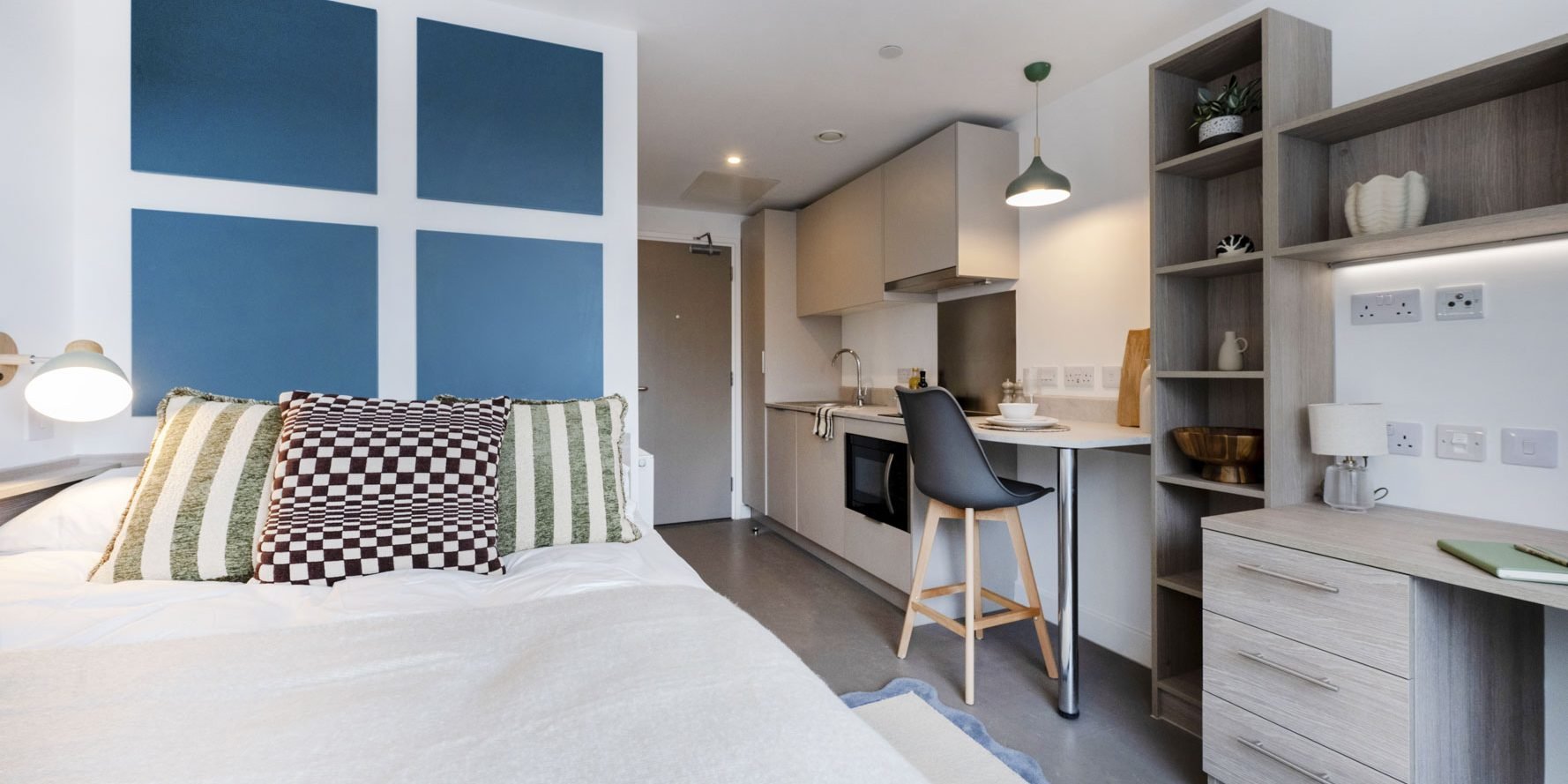 Fully furnished student bedroom at Timber Yard Bristol featuring bespoke fitted furniture, including a bed, study desk, wardrobe and storage solutions.