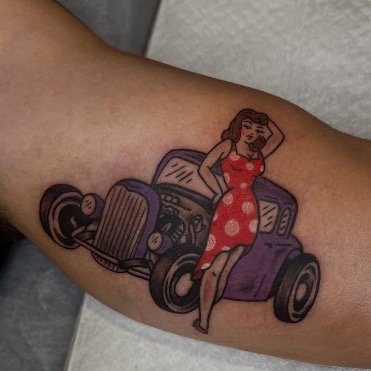Tradition tattoo style pin-up girl in polka dots  and posing in front of a hot rod in full color 1950’s style Art 