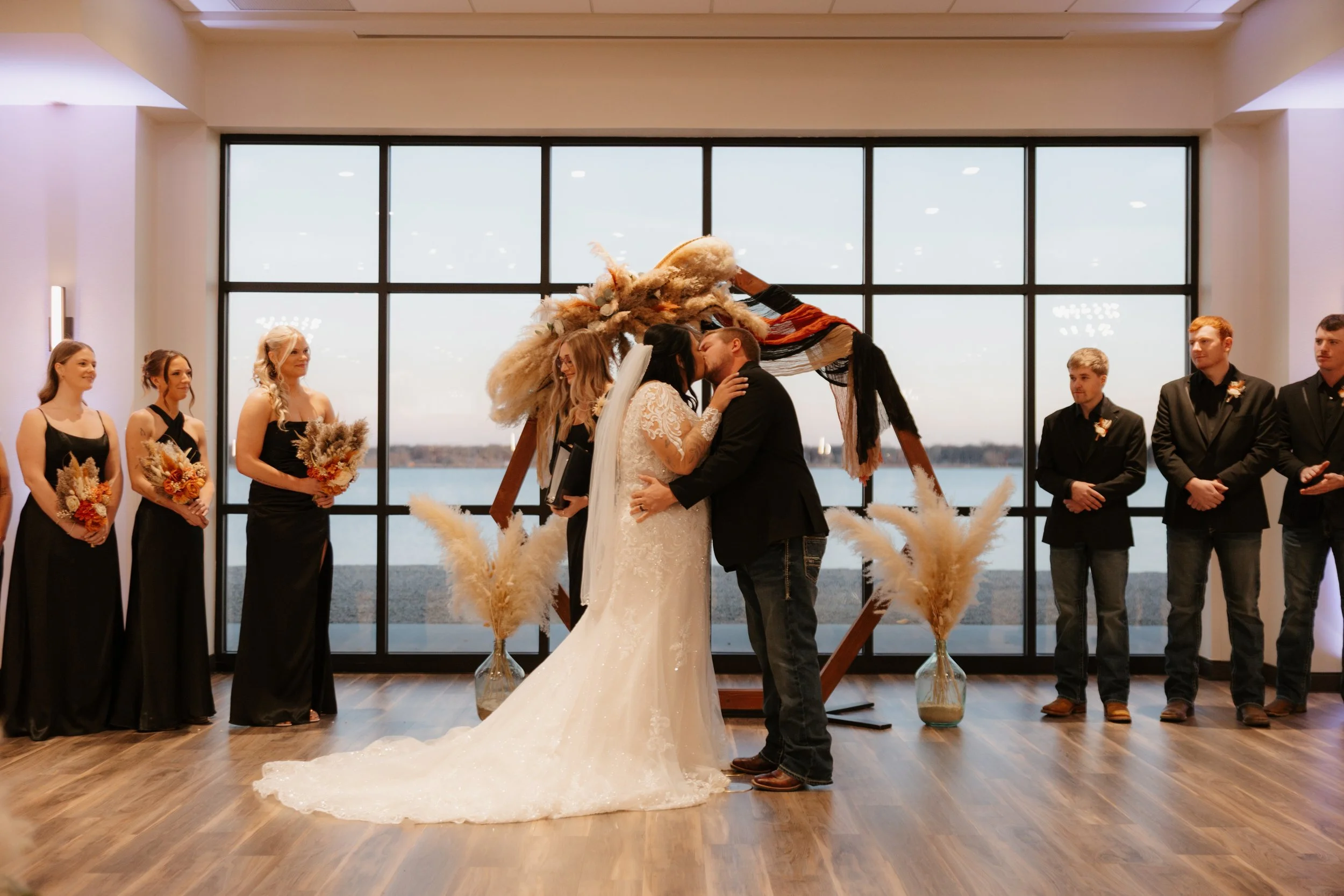 Close-up of a hand holding a golf ball with personalized text. The person is wearing bracelets and a ring, with the focus on the ball and hand.