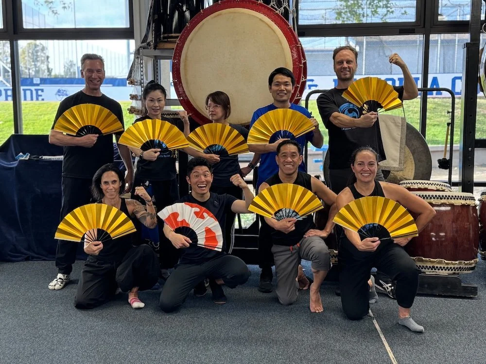 La Jolla Taiko group photo with Taiyo Onoda of Kodo holding traditional Onikenbai Japanese fans