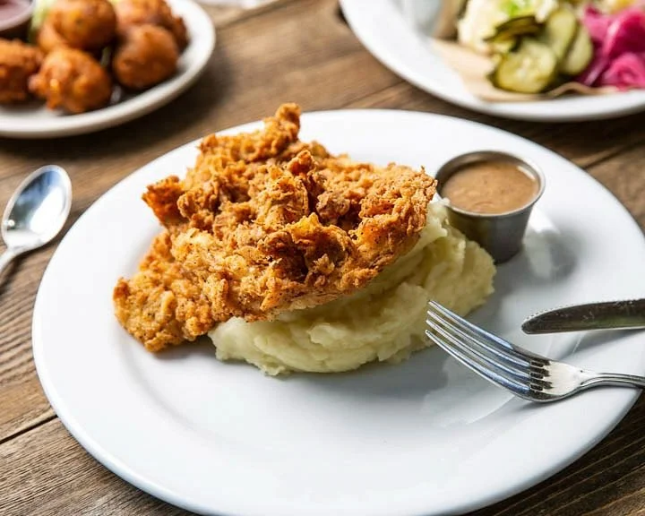 Dinner comfort on a plate. Our buttermilk-battered fried chicken, hot from the fryer served with creamy mashed potatoes, tasso ham gravy, and your choice of collard greens or coleslaw.⁠
⁠
Available at both locations, and for takeaway! ⁠
⁠
#screendoor