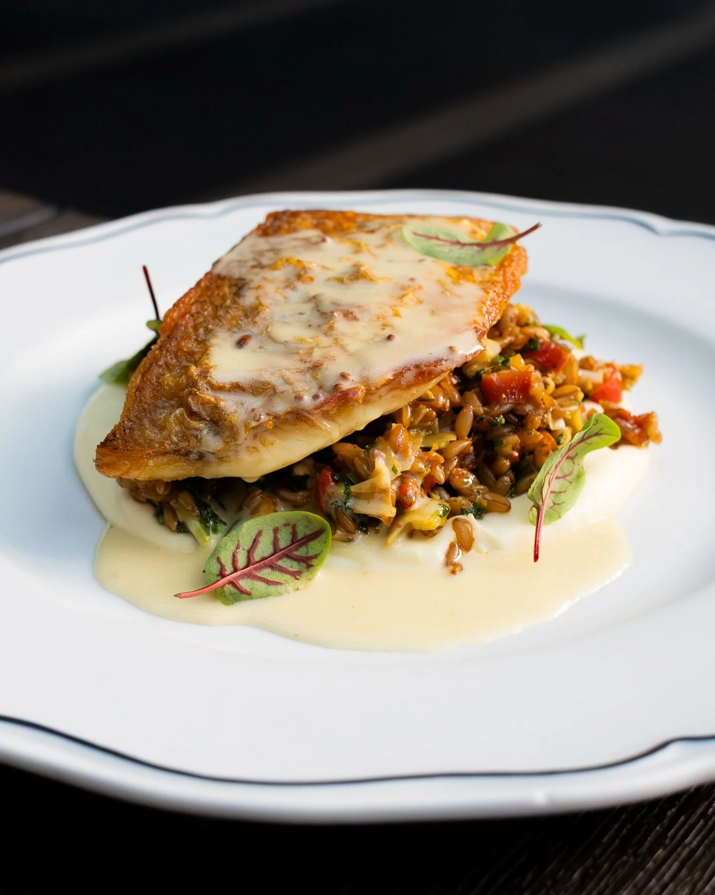 Pan-Roasted Snapper served over farro, caramelized leeks, slow-stewed peppers, silky parsnip cream, vibrant mustard greens, pecan persillade, and finished with a Creole mustard beurre blanc.⁠
⁠
#screendoorpdx #pdxfood #portlandfood #travelportland #e