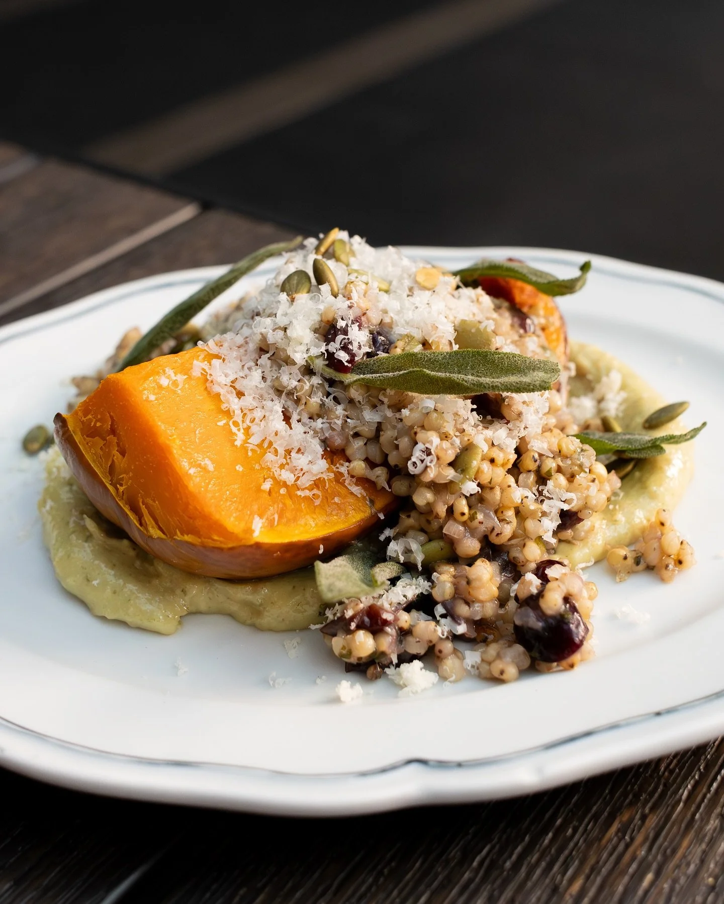 Fall on a plate 🤩 Roasted squash with sorghum pilaf, dried cranberries, toasted pepitas, crispy sage, parmesan, and a nutty pumpkin seed spread.⁠
⁠
#screendoorpdx #pdxfood #portlandfood #travelportland #exploreportland