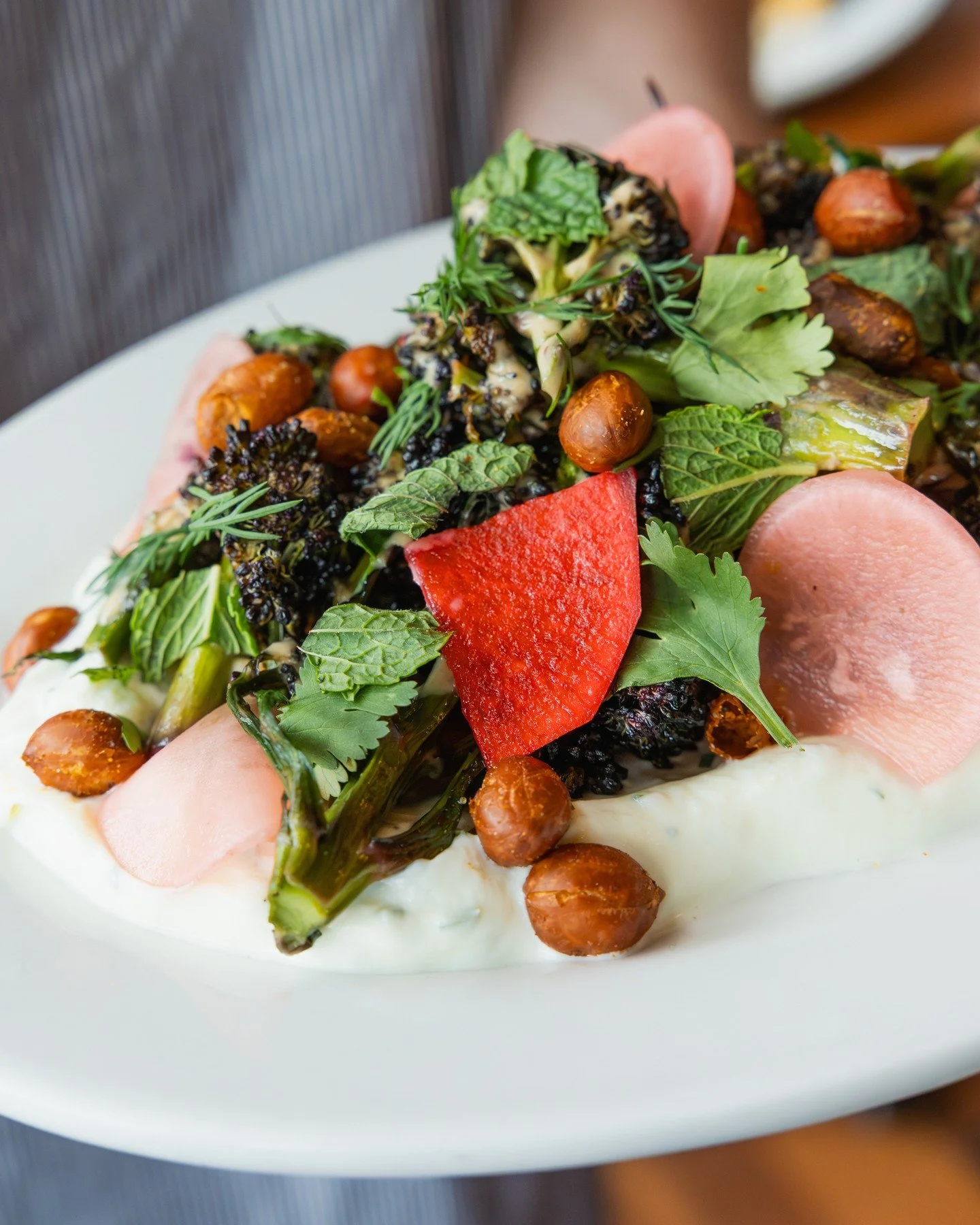 A little bright, a little crunchy, a little creamy: Purple sprouting broccoli with whipped farmer&rsquo;s cheese, benne-peanut sauce, cajun fried peanuts, and pickled garden radish. On our dinner menu for a limited time!⁠
⁠
#screendoorpdx #pdxfood #p