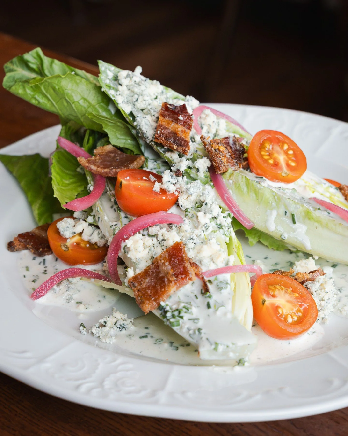 Romaine Hearts Wedge Salad 🥗 crisp romaine heart lettuce with buttermilk blue cheese dressing, candied bacon, pickled red onions, cherry tomatoes, and blue cheese crumbles.⁠
⁠
Join us for dinner from 4:30pm to 9pm!⁠
⁠
#screendoorpdx #pdxfood #portla