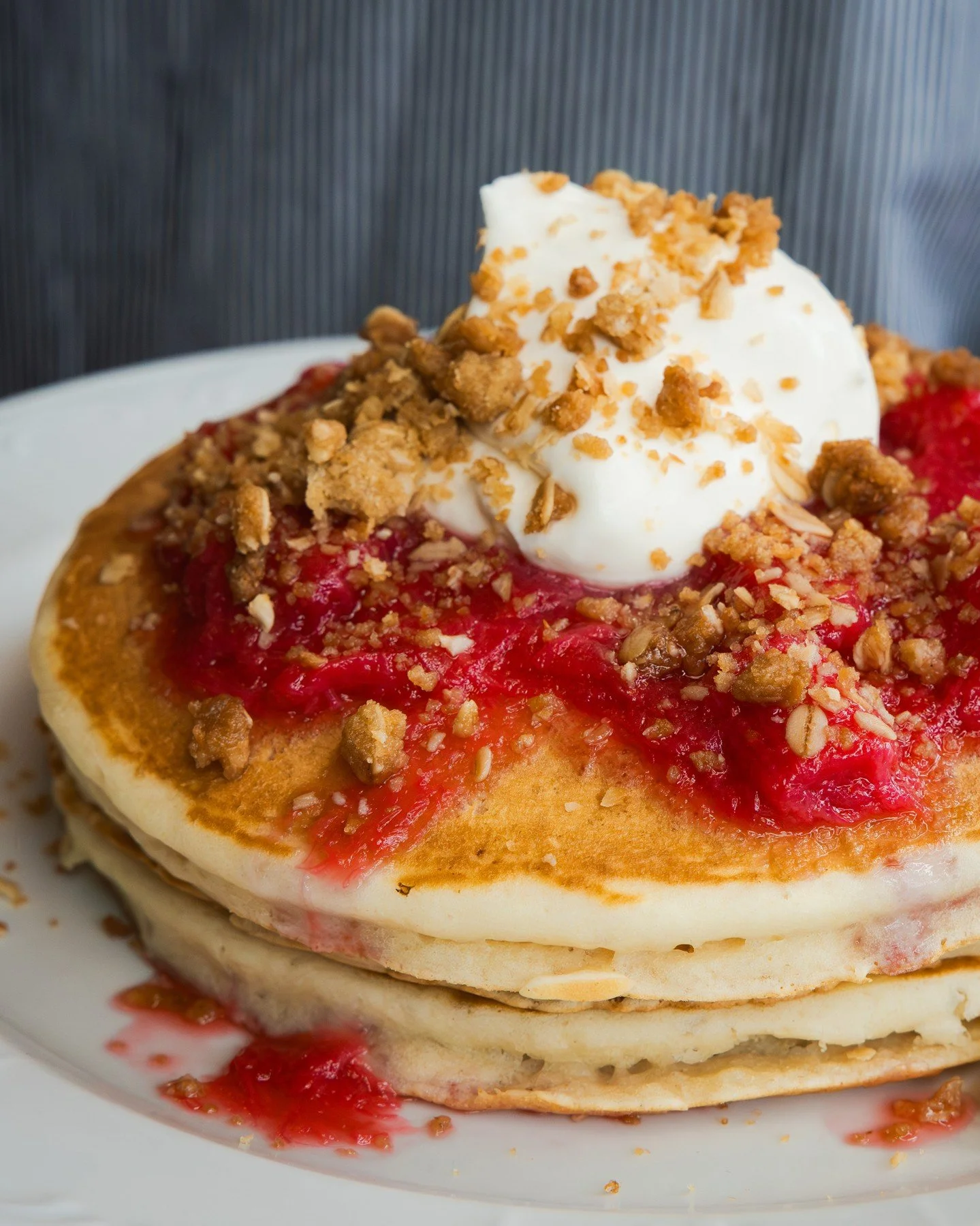 Well now&hellip; here&rsquo;s a stack worth waking up for 🥞 Three fluffy buttermilk pancakes topped with poached rhubarb compote, whipped cr&egrave;me fra&icirc;che, orange zest, and coconut oat crumble.⁠
⁠
#screendoorpdx #pdxfood #portlandfood #tra