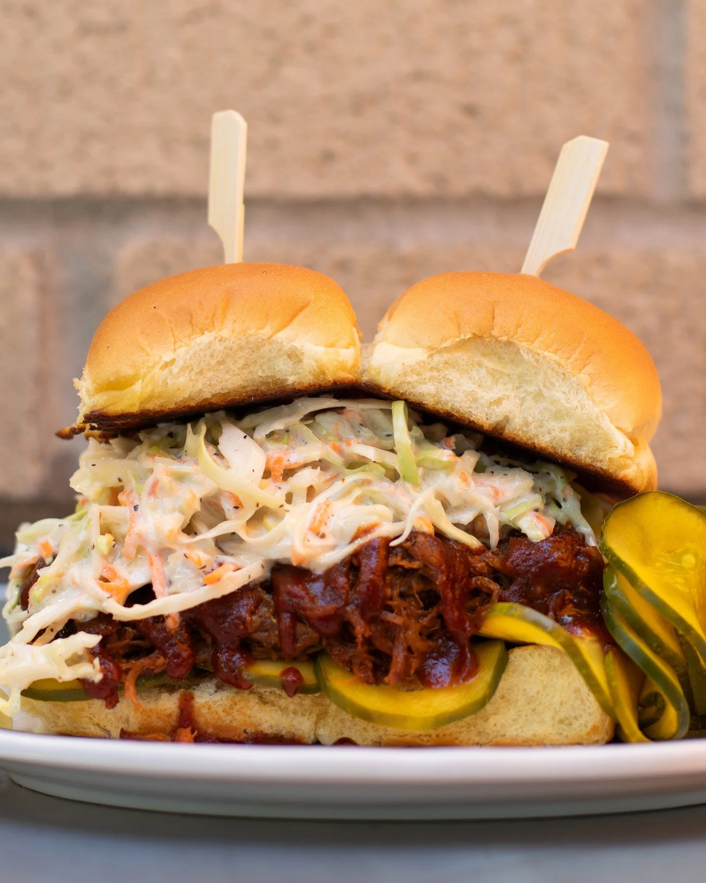 A happy hour favorite 🍔Pulled Pork Sliders with hickory smoked pork shoulder, Memphis-style BBQ, coleslaw, and house B&amp;B pickles.⁠
⁠
Available at both locations during the first and last hour of service. A great place to be before or after your 