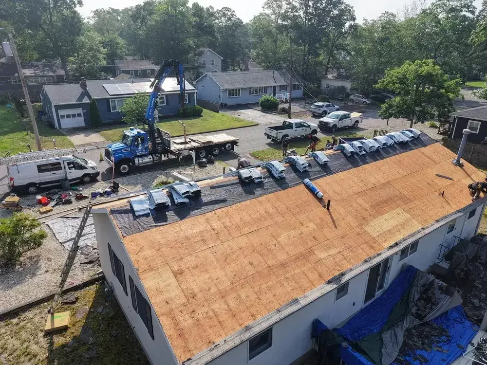 GRM Roofing team reinstalling solar panels after completing a new roof installation in Southern NJ