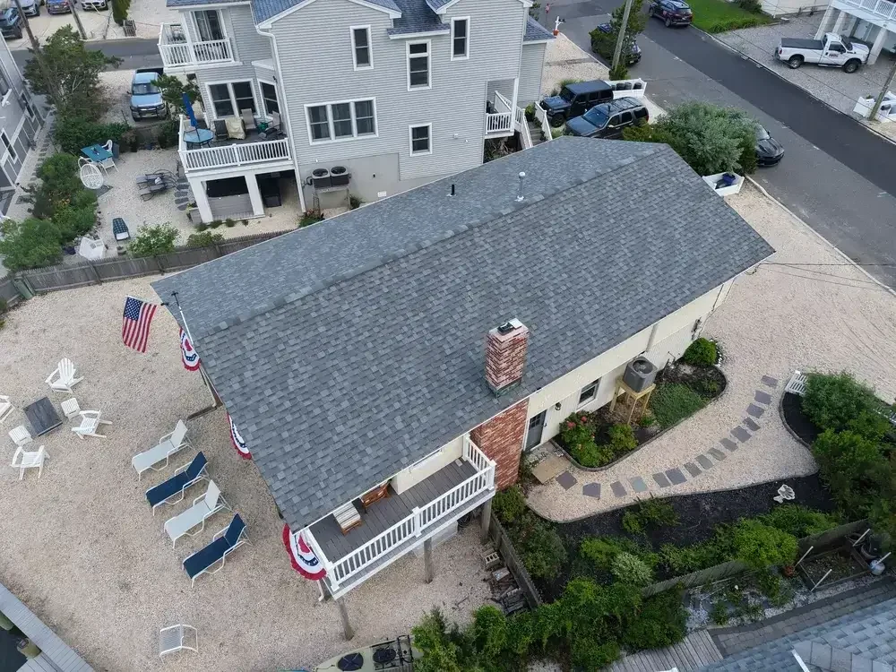 GRM Roofing contractor performing a roof inspection on a residential home in Little Egg Harbor, NJ