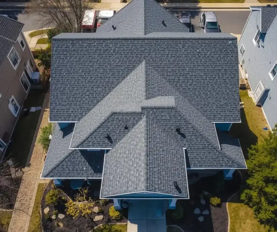Aerial view of a completed gray asphalt shingle roof on a multi-gable residential home in Ocean County NJ