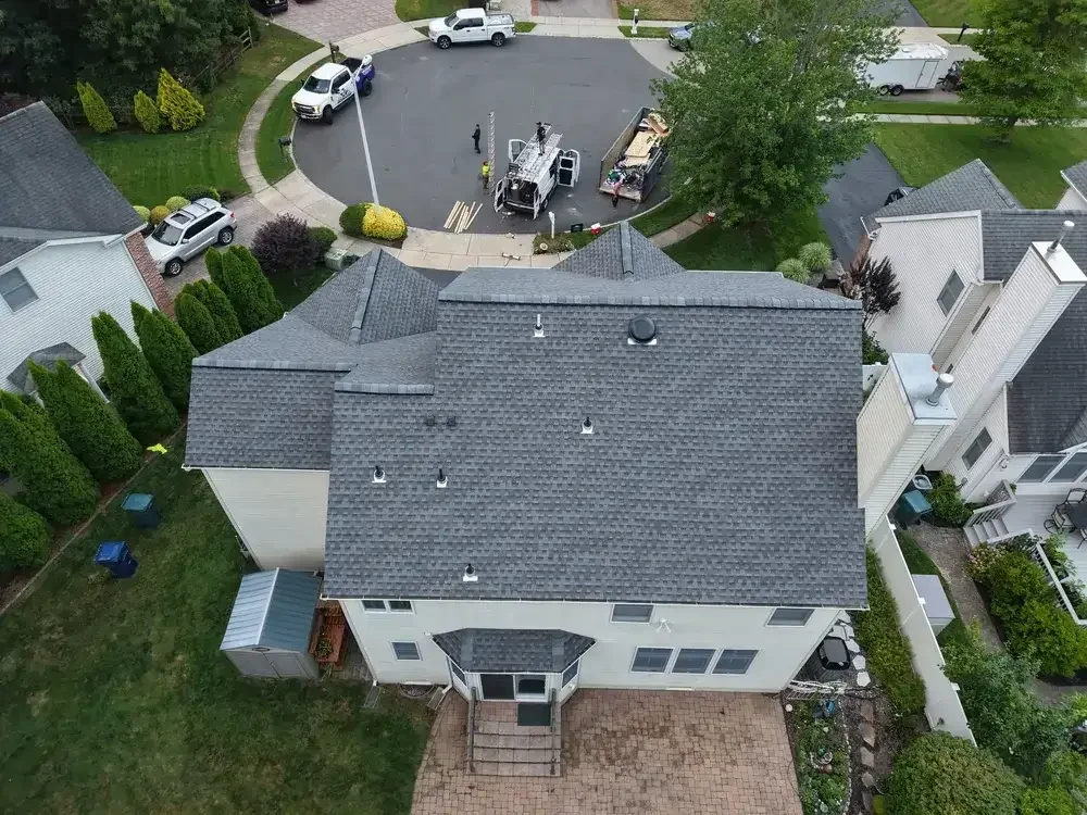 GRM Roofing technician repairing damaged shingles on a home in Little Egg Harbor, NJ