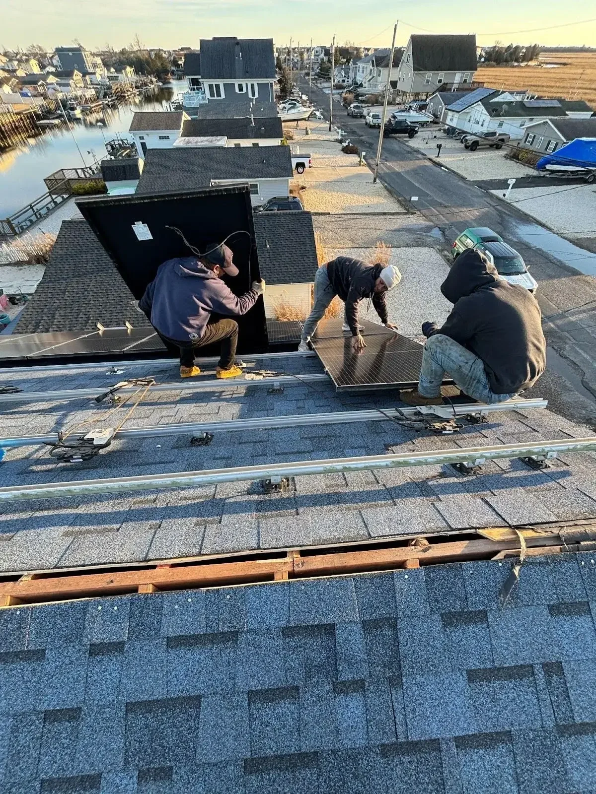 contractors fixing solar panels on roof.webp