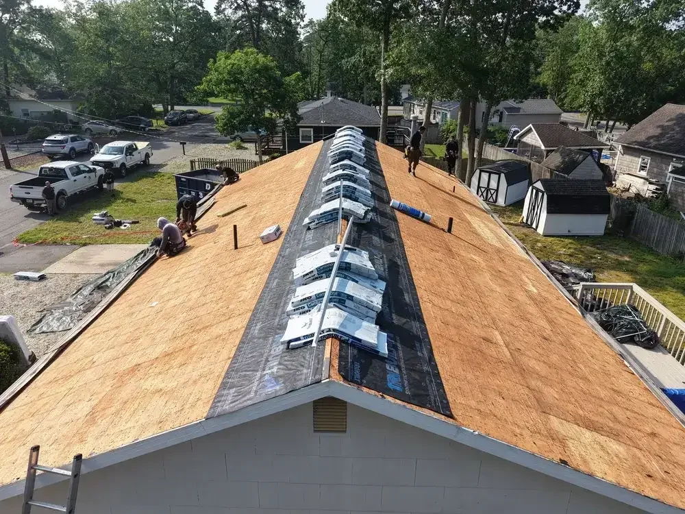 Roof replacement in progress with solar panels safely removed by GRM Roofing in Ocean County