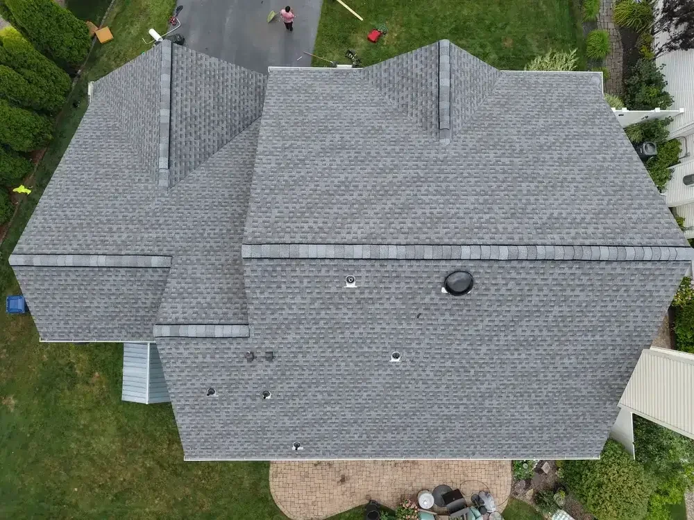 GRM Roofing contractor performing routine roof maintenance on a home in Little Egg Harbor, NJ