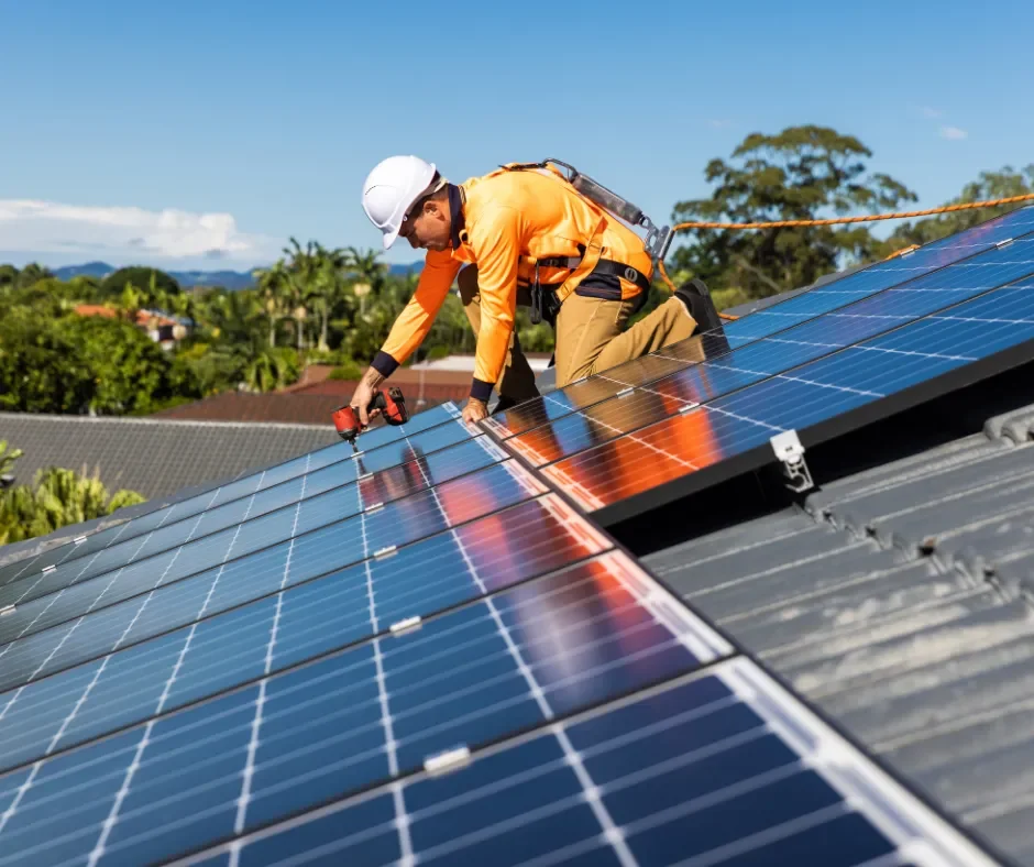 Technician securing solar panels during a detach and reset on a residential roof in Little Egg Harbor, NJ