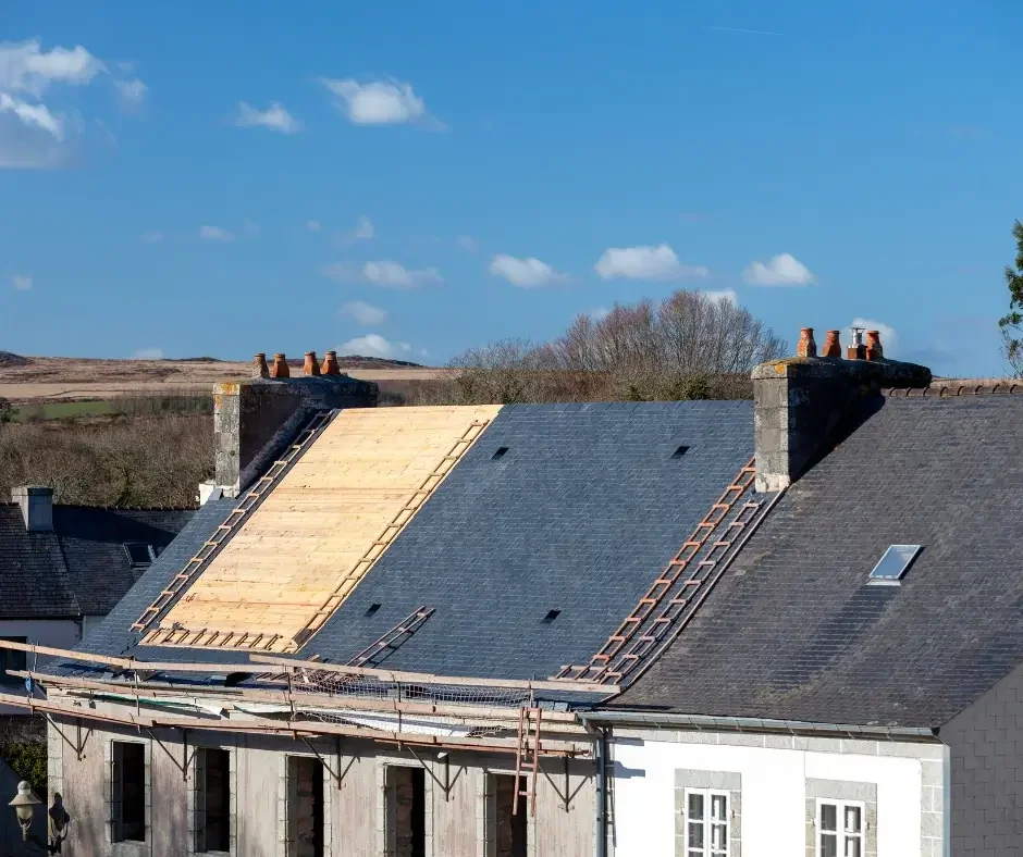 Roof repair in Ocean County NJ with exposed wood decking and slate shingles being replaced on a residential property