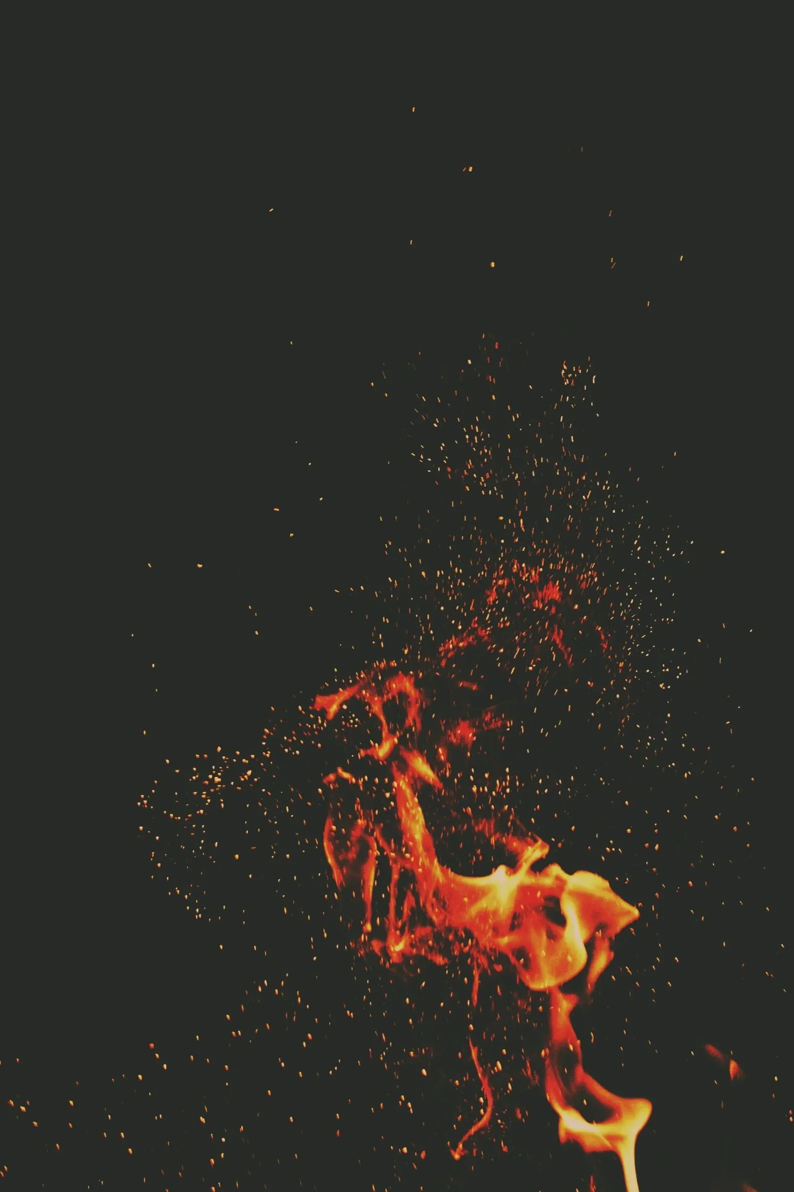 Fiery sparks and flames against a dark background.
