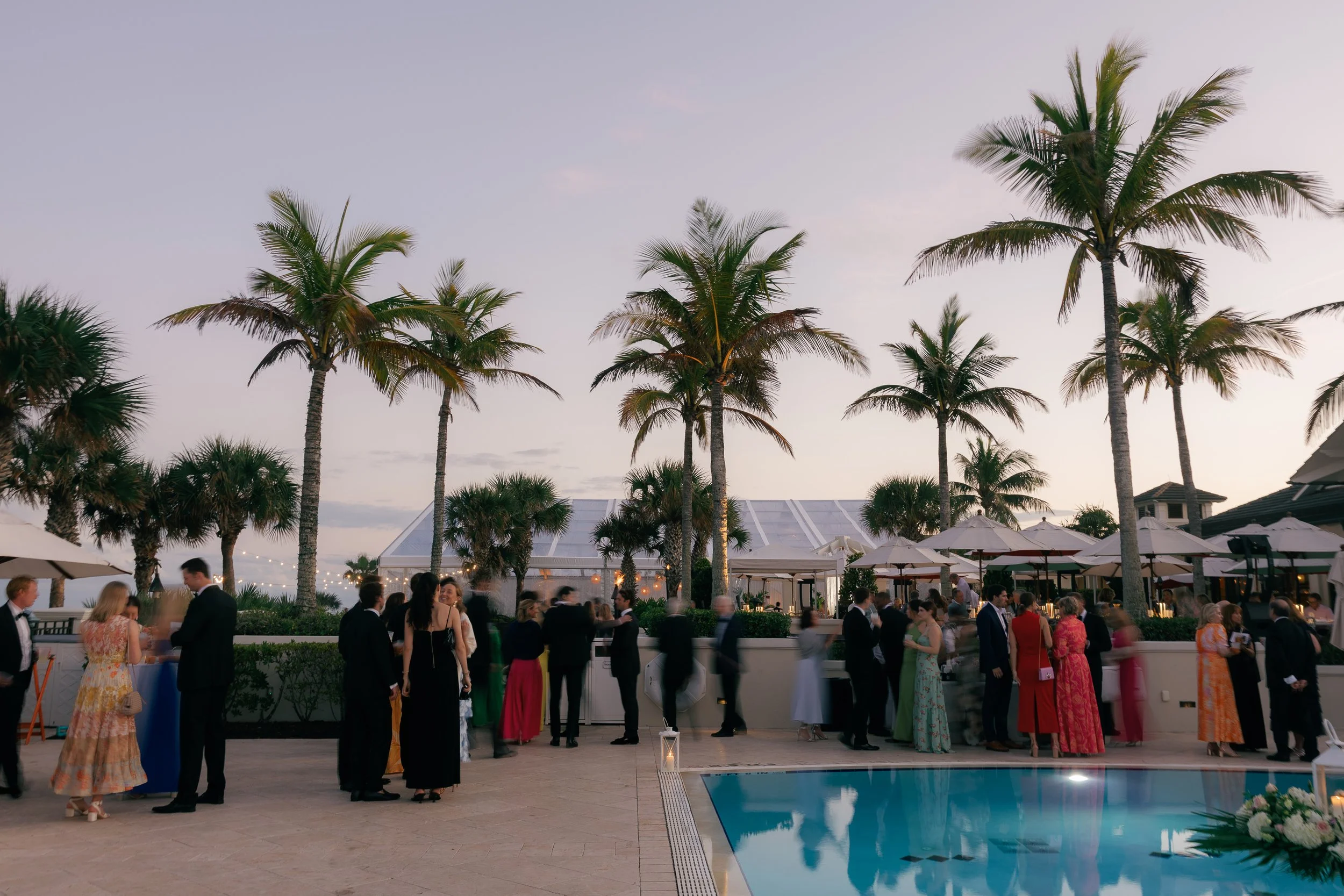 Bride in a white wedding dress holding a bouquet of white flowers.