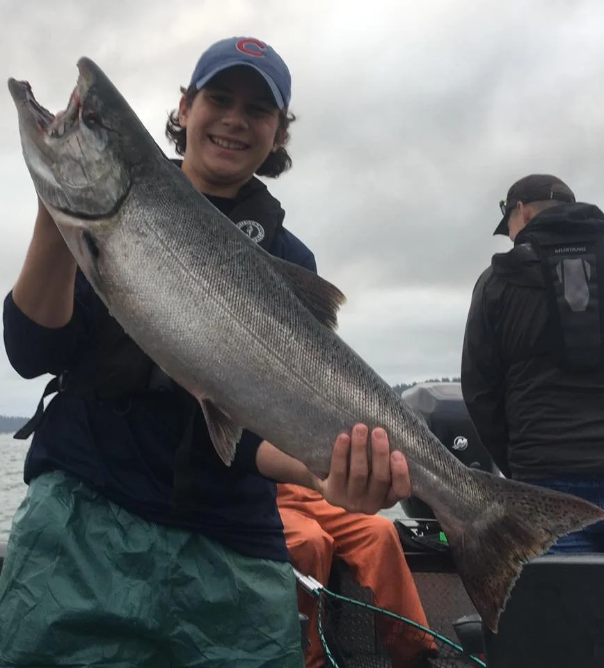man holding salmon caught with fishing charter in Oregon