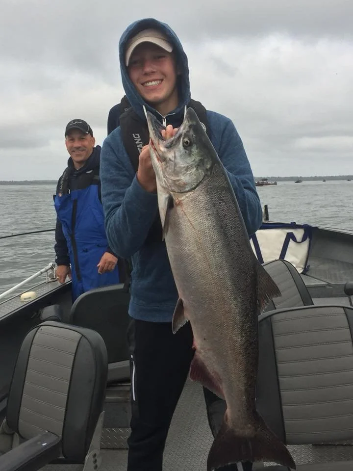 man holding salmon caught with fishing charter in Oregon