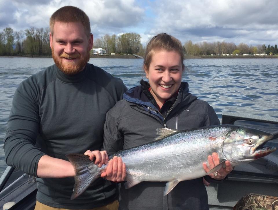 fishermen holding up silver chinook salmon caught with fishing charter in Oregon