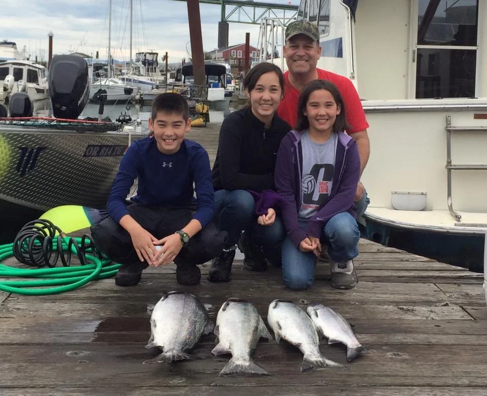 fishermen with silver chinook salmon caught with fishing charter in Oregon