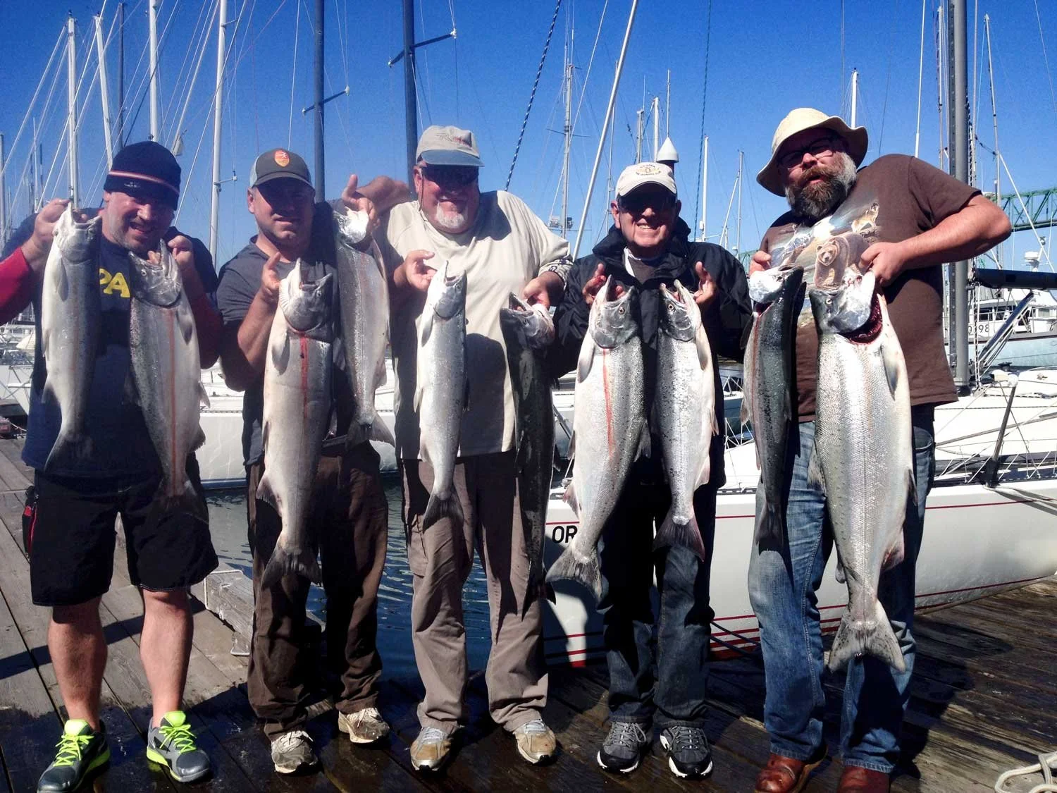 Group of fishermen holding chinook salmon they caught in Oregon