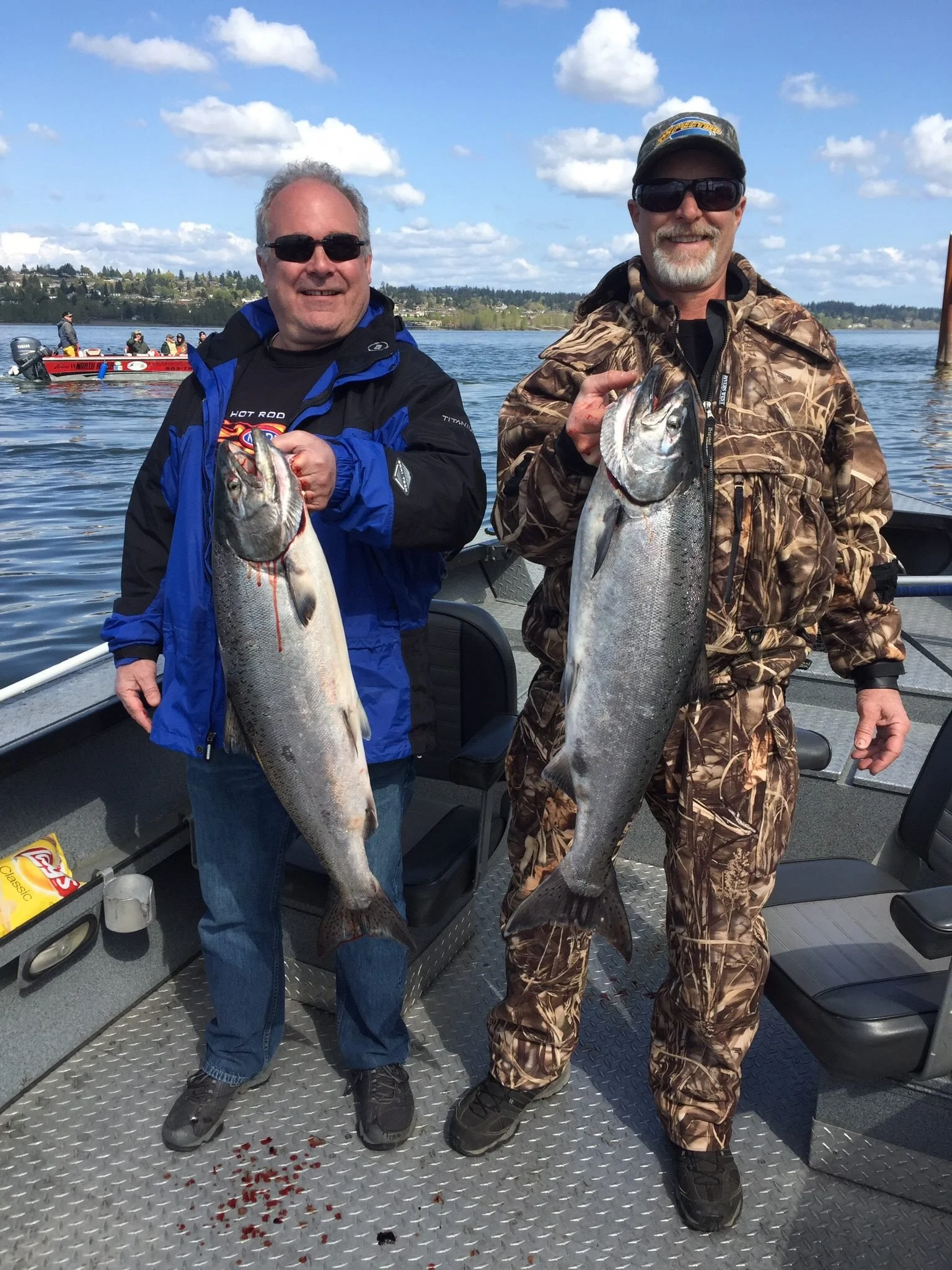 fishermen holding up silver chinook salmon caught with fishing charter in Oregon