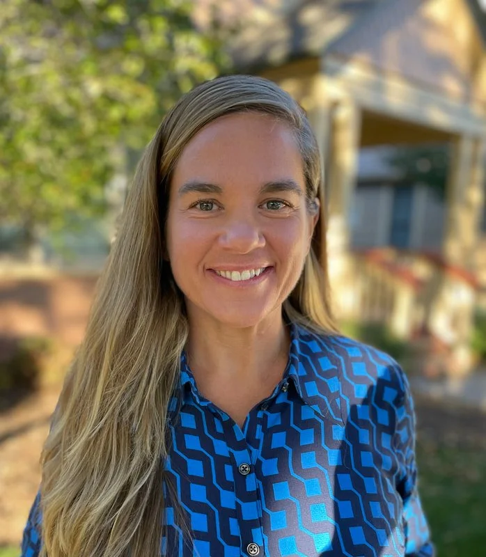 Dr. Brita Mutti, naturopathic doctor specializing in women’s health and preventative medicine, smiling in a professional setting, embodying empowerment, health, and holistic wellness.
