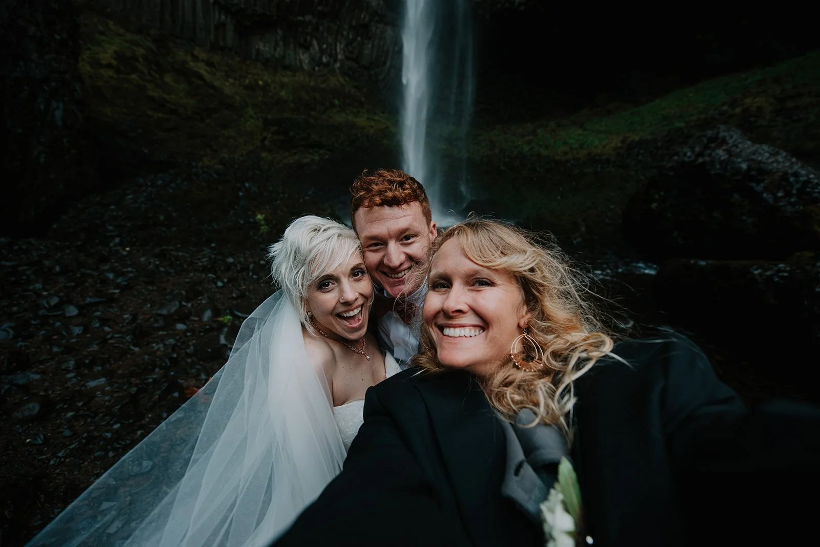 Waterfall wedding ceremony in the Columbia river gorge, selfie with photographer, bride, and groom.