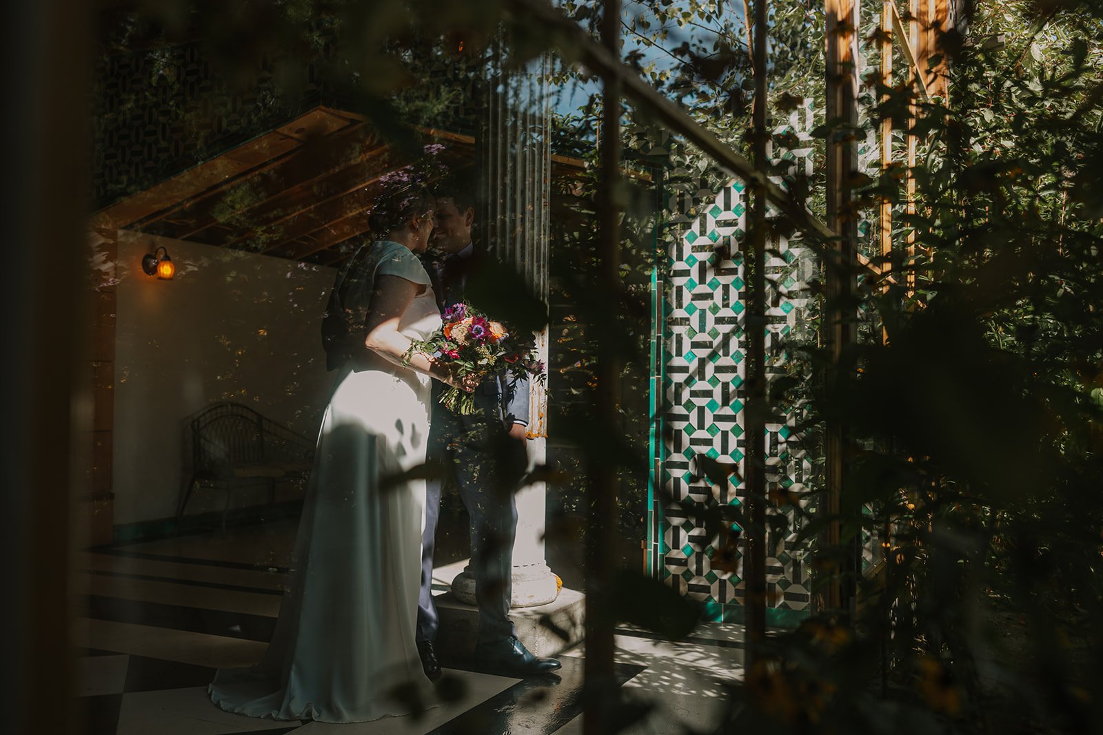 Portrait of bride and groom sharing intimate candid moment in the Apple House at Oregon wedding venue, Mt. Hood Organic Farms.