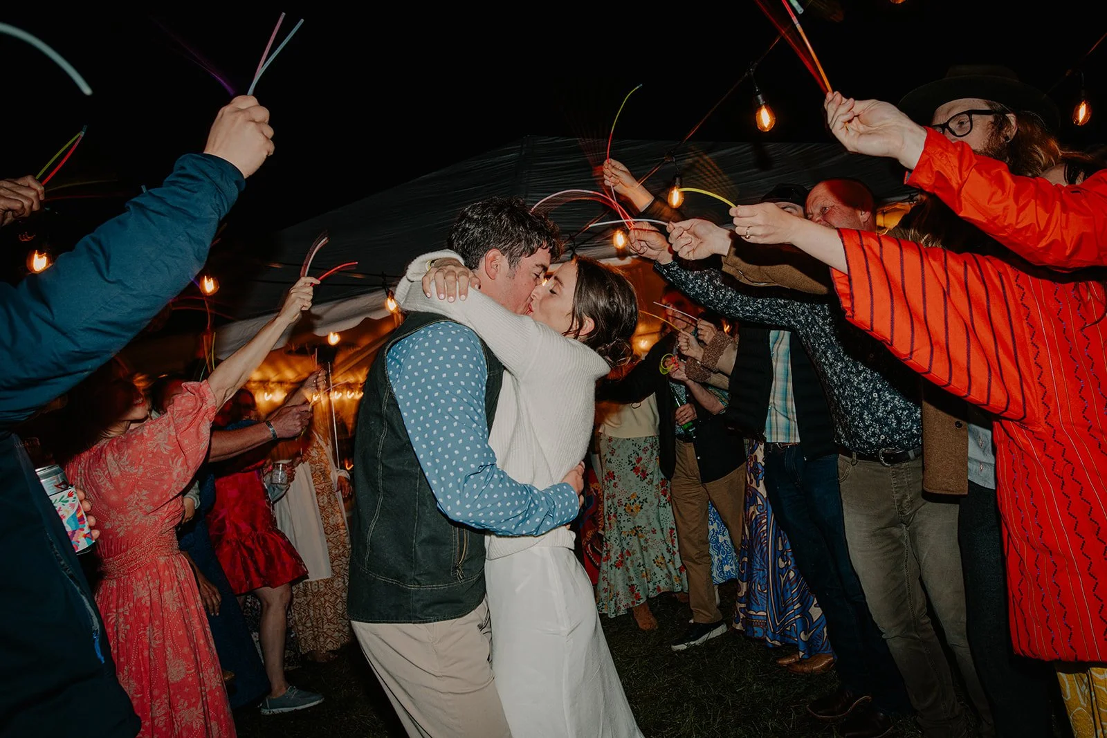 Bride and groom making grand exit with glow sticks at outdoor wedding ceremony in Missoula, MT.