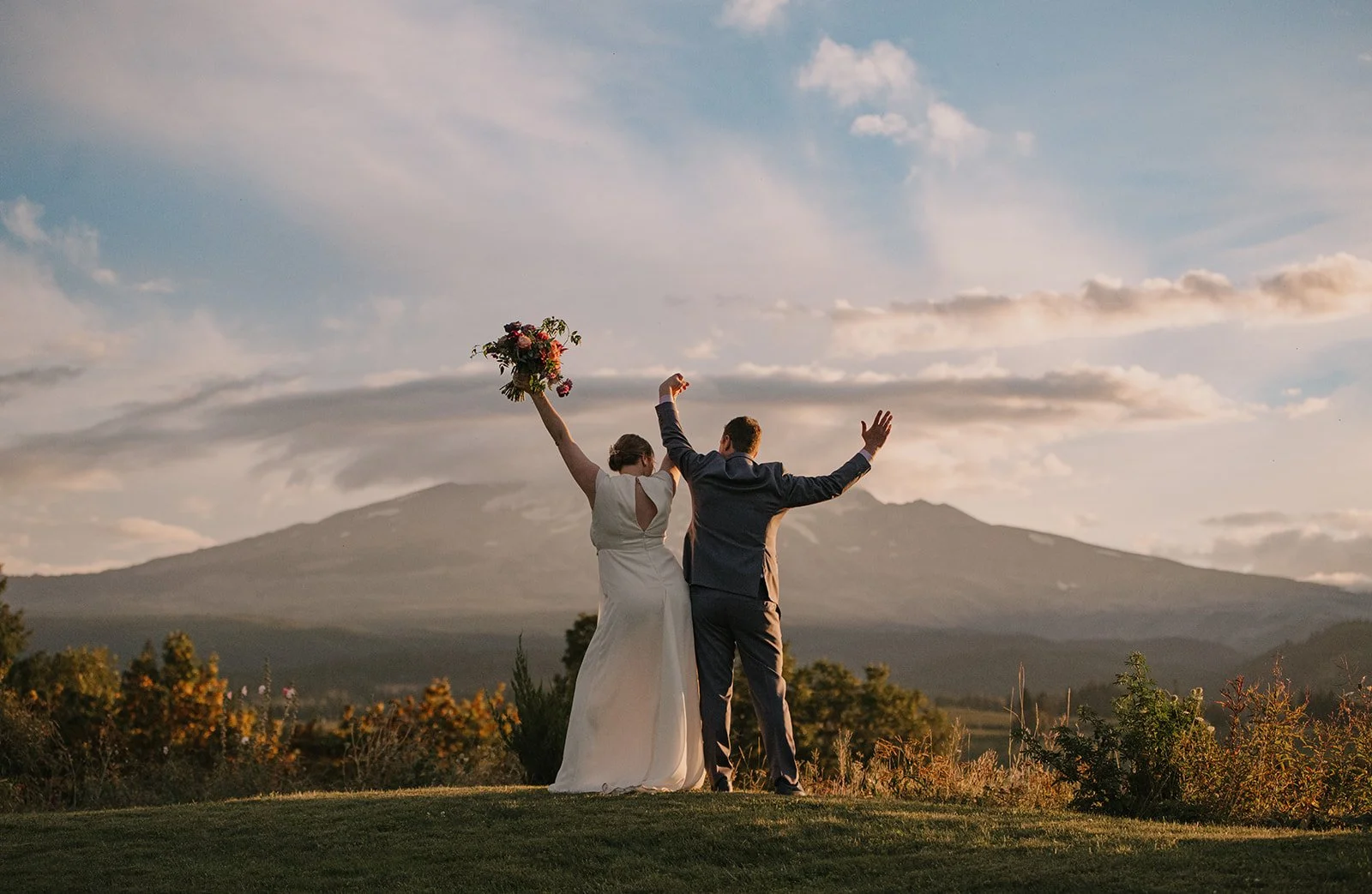 Bride and groom celebrating during golden hour reception at Oregon wedding venue, Mt. Hood Organic Farms.